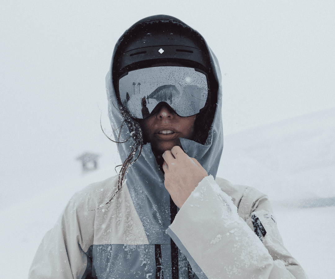 Girl wearing ski goggles on a snowy mountain