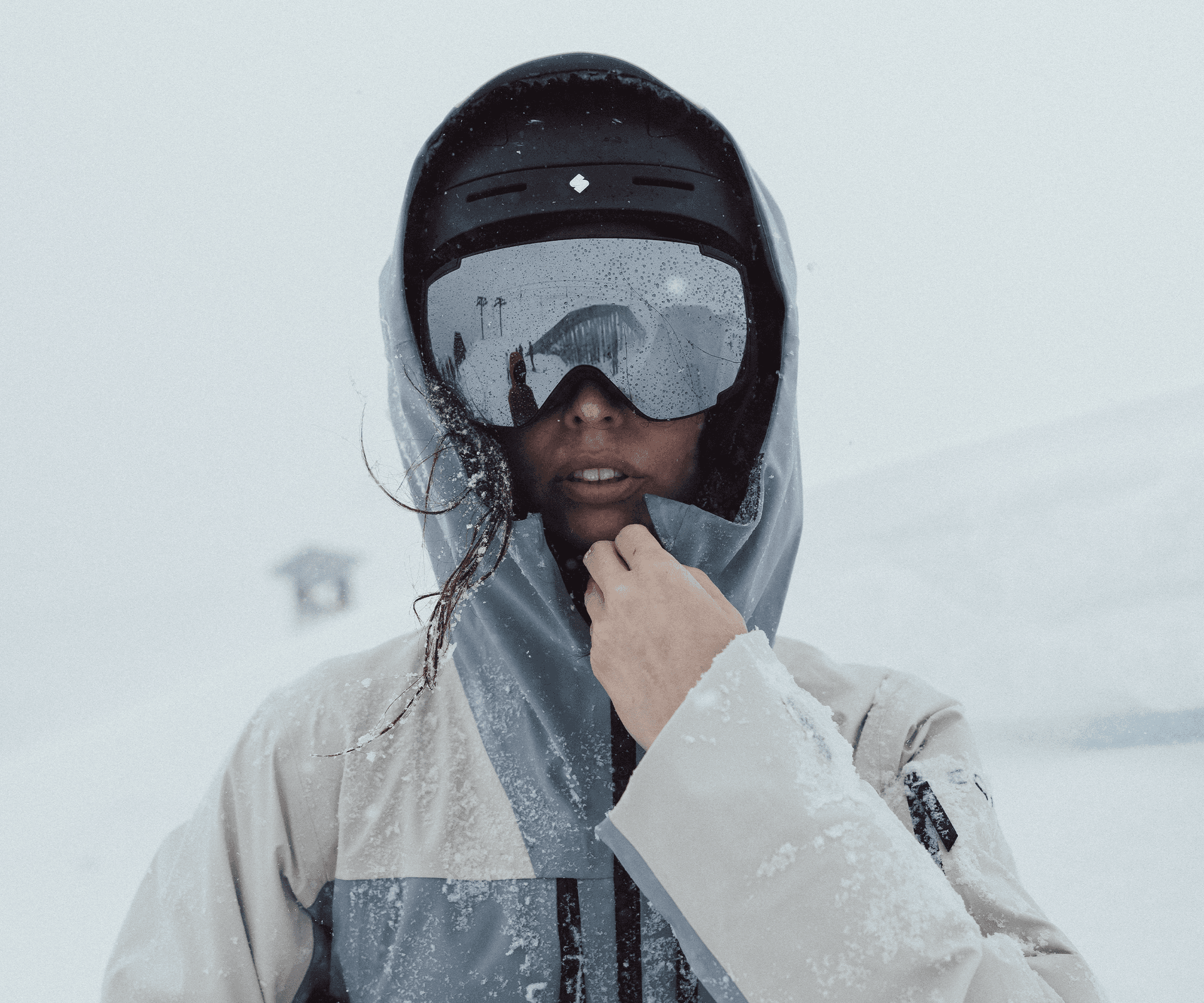 Girl wearing ski goggles on a snowy mountain