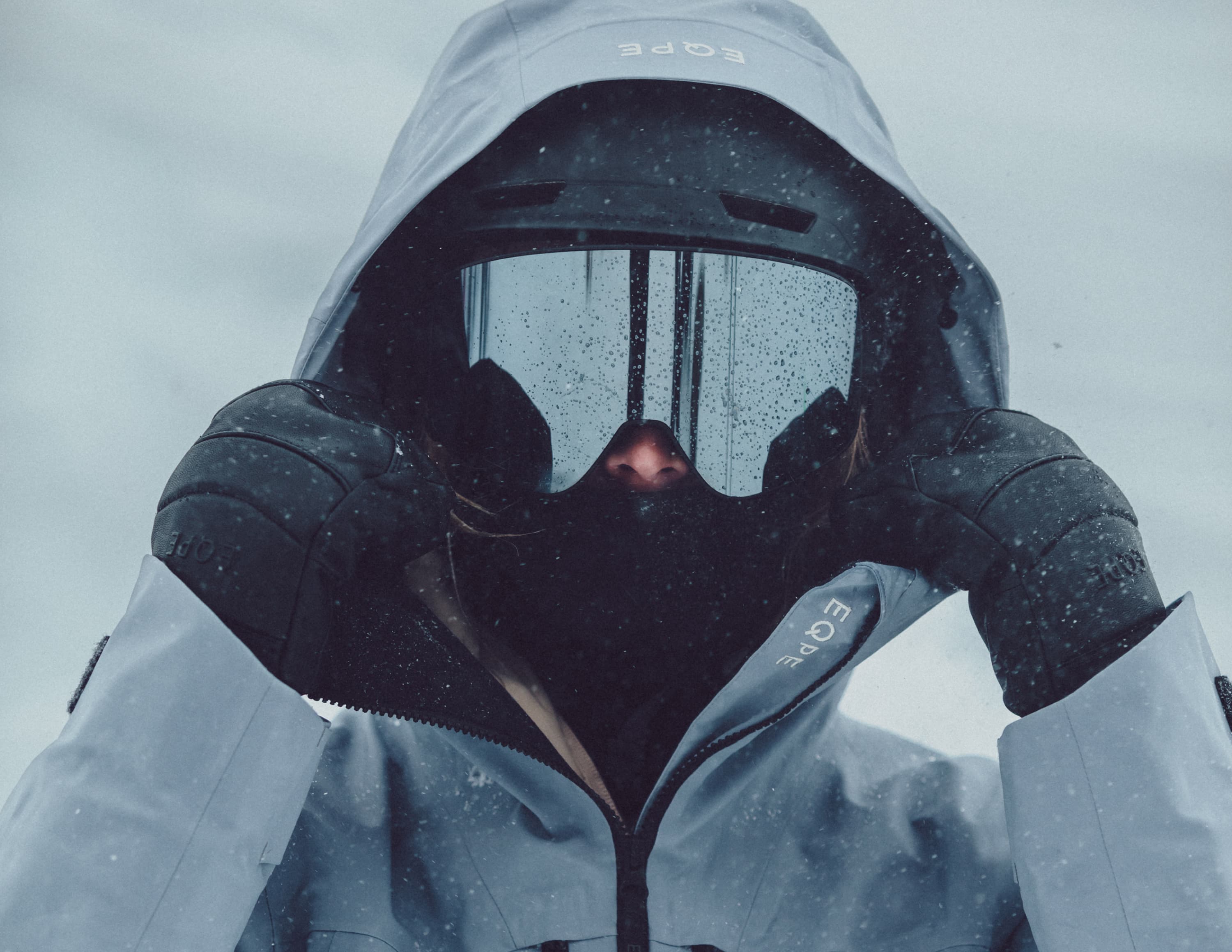 Person in ski gear standing in snowy conditions.